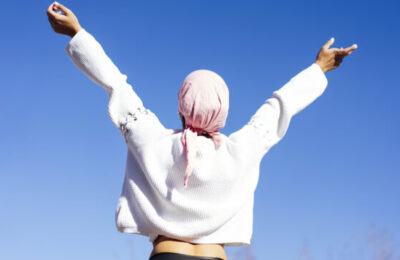 woman with pink headscarf, has cancer